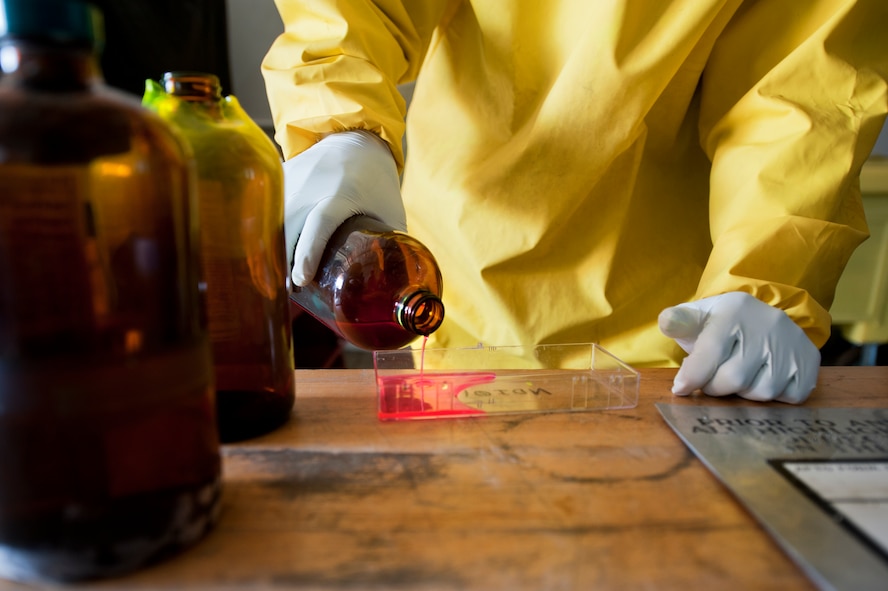 Airman 1st Class Courtney Harrah, 5th Maintenance Squadron non-destructive inspection apprentice, performs a Cracked Chrome Panel test for the stationary fluorescent penetrant inspection line.  The purpose of this test is to evaluate our in use inspection materials against a control set. (U.S. Air Force photo/Senior Airman Brittany Y. Bateman)