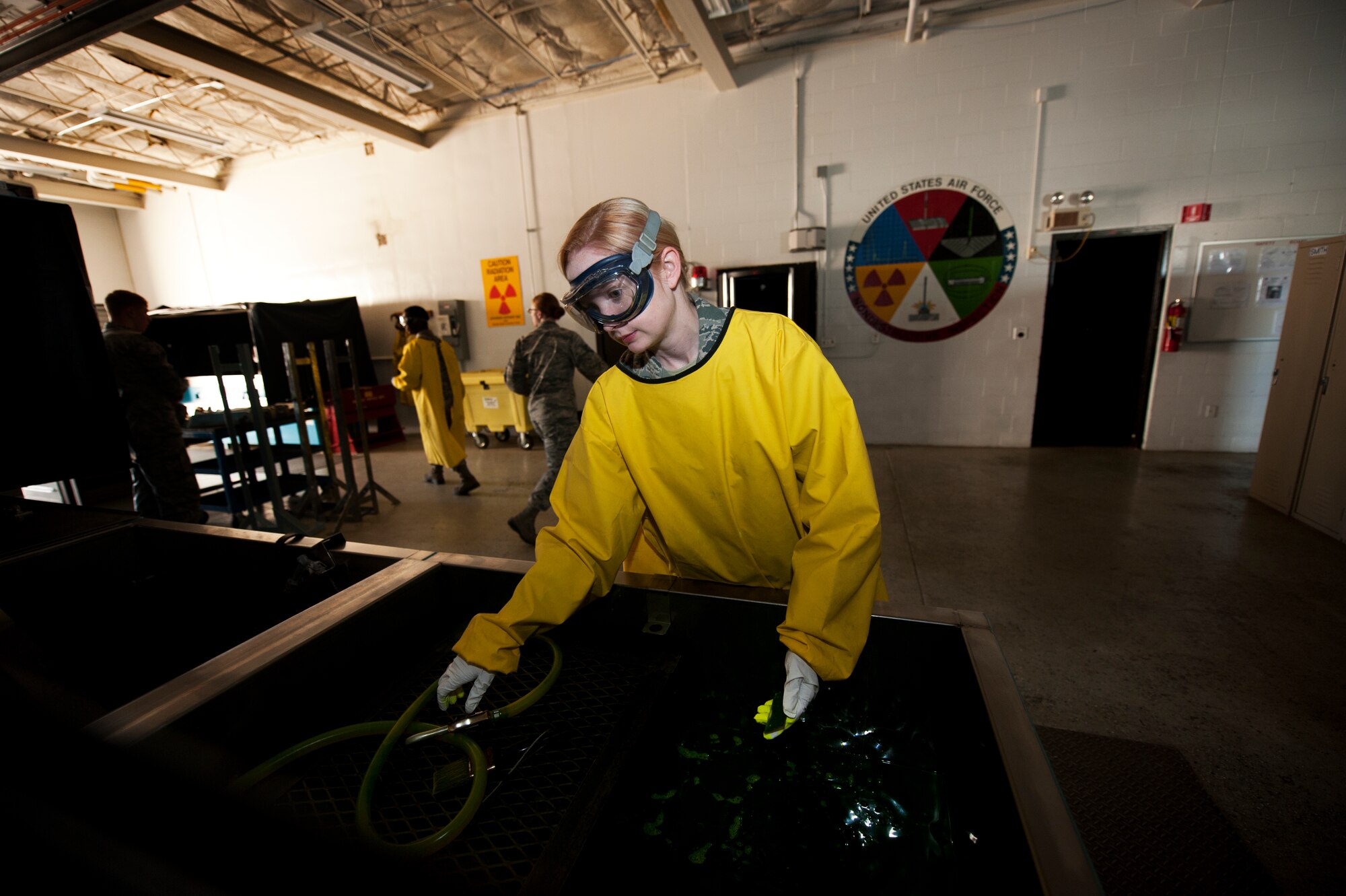 Airman 1st Class Courtney Harrah, 5th Maintenance Squadron non-destructive inspection apprentice, performs a Cracked Chrome Panel test for the stationary fluorescent penetrant inspection line.  The purpose of this test is to evaluate our in use inspection materials against a control set. (U.S. Air Force photo/Senior Airman Brittany Y. Bateman)