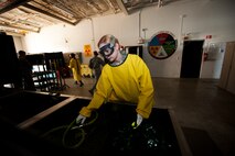 Airman 1st Class Courtney Harrah, 5th Maintenance Squadron non-destructive inspection apprentice, performs a Cracked Chrome Panel test for the stationary fluorescent penetrant inspection line.  The purpose of this test is to evaluate our in use inspection materials against a control set. (U.S. Air Force photo/Senior Airman Brittany Y. Bateman)