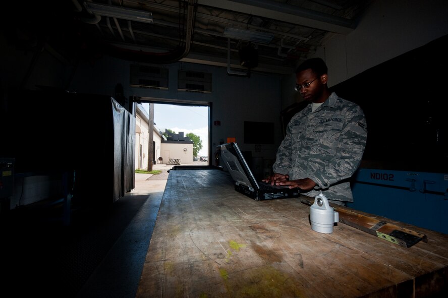 Airman 1st Class Clarence Tobias, 5th Maintenance Squadron non-destructive inspection apprentice, performs an Eddy Current surface scan of a heat exchanger. The NDI laboratory operates 24 hours a day to guarantee no defects in Minot’s aircraft fleet are overlooked.  (U.S. Air Force photo/Senior Airman Brittany Y. Bateman)