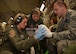 TSgt. Sarah Starkey and MSgt. Nicole Morales “treat” SrA. Beau Brown during an in-flight aeromedical training exercise, Aug. 11, aboard a C-17 Globemaster III. All three Airmen are reservists with the 439th Aeromedical Evacuation Squadron, which performs periodic exercises like these aboard other military aircraft including KC 135s and C-130s. See additional photos on page 7. (U.S. Air Force photo/A1C Monica Ricci)