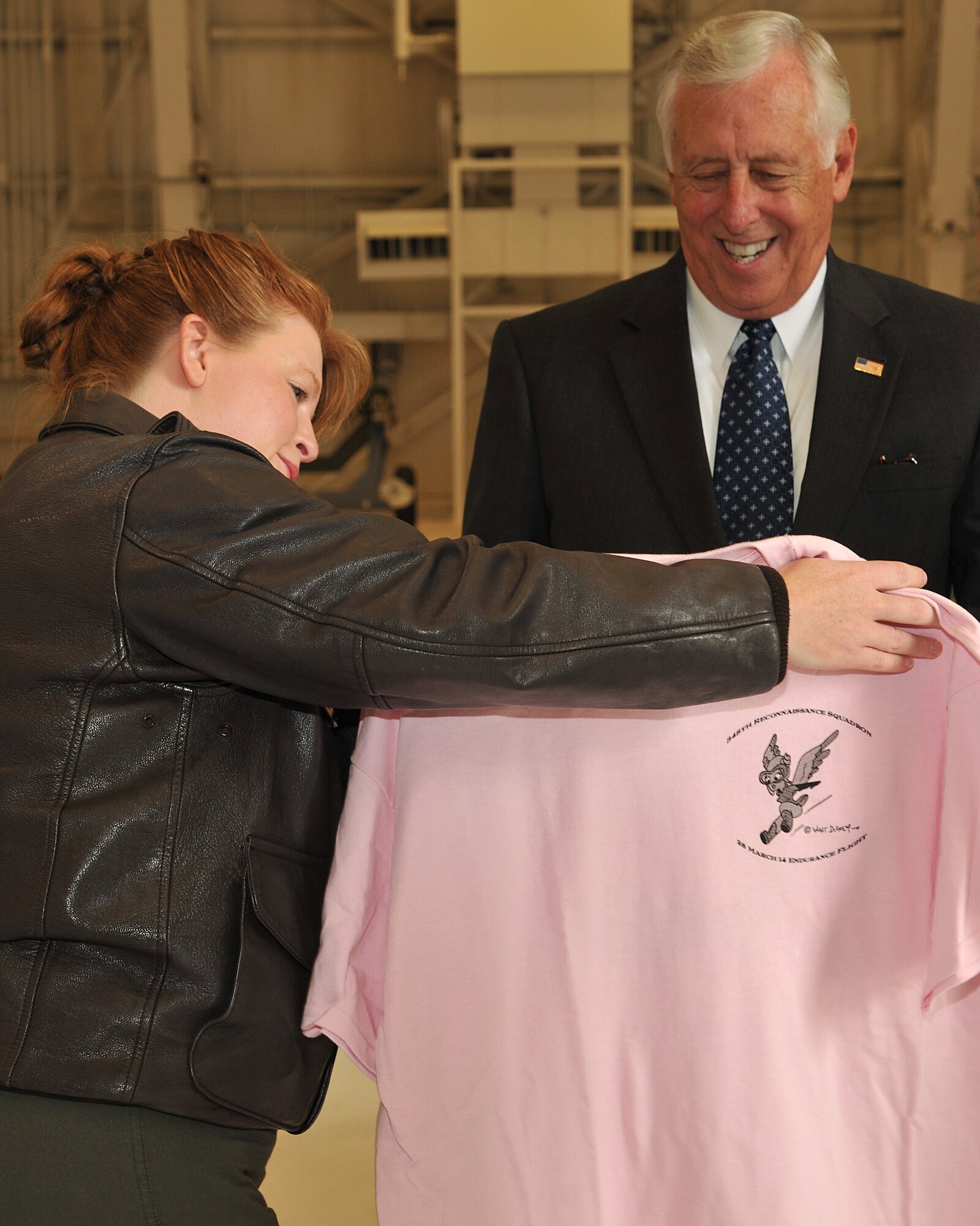 Lt. Col. Amanda Brandt, 348th Reconnaissance Squadron commander, presents Congressman Steny Hoyer with a t-shirt during a base visit Aug. 28, 2014, on Grand Forks Air Force Base, N.D. Hoyer visited the base to learn about the Global Hawk mission and the integration of unmanned aircraft into commercial airspace. (U.S. Air Force photo/Senior Airman Xavier Navarro) 