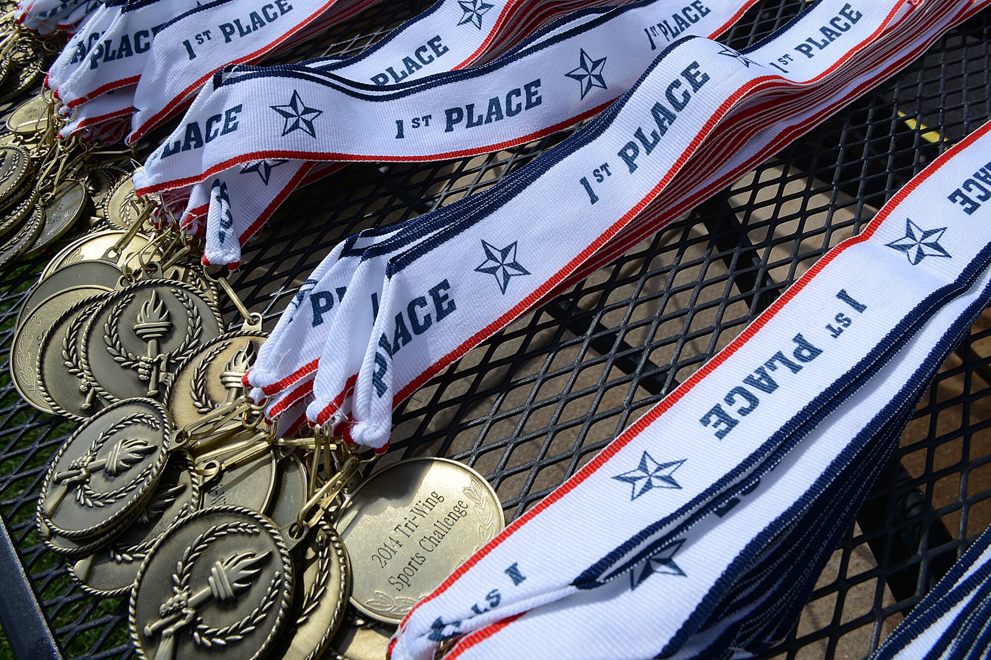 PETERSON AIR FORCE BASE, Colo. -- Medals to be handed out to the victors of individual Tri-Wing Sports Challenge events lie on a table during the awards ceremony. The Tri-Wing Sports Challenge was an opportunity for Airmen from Buckley AFB, Peterson AFB and Schriever AFB to strengthen the bonds of camaraderie in an environment outside of the workplace. The 21st Space Wing won the first years’ event, amassing 93 points. Schriever came in second place with 62 points and Buckley in third with 38 points. (U.S. Air Force Photo/Rob Bussard)