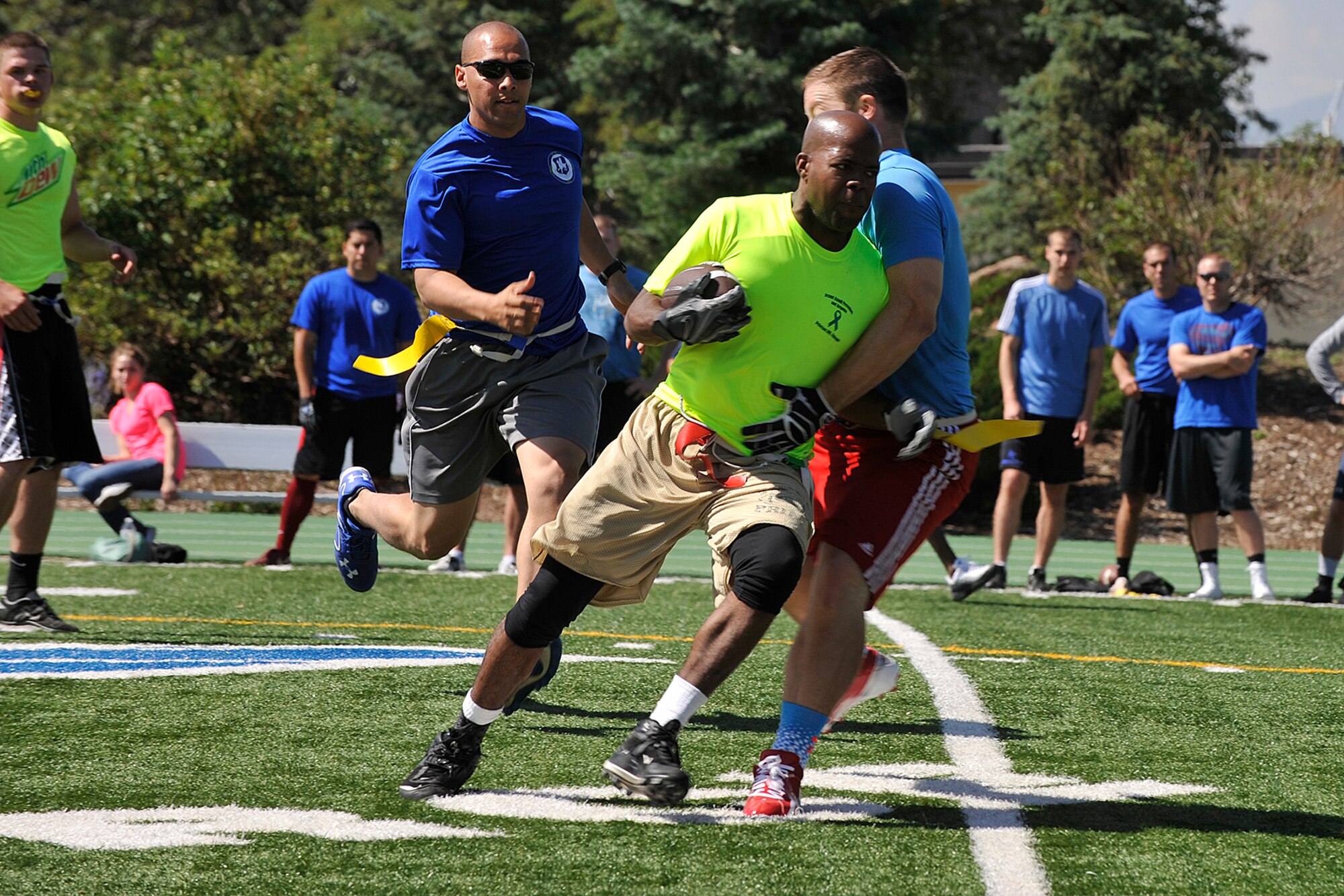 PETERSON AIR FORCE BASE, Colo. -- Peterson Air Force Base and Schriever Air Force Base compete in a football game during the first-ever Tri-Wing Sports Challenge Aug. 27 hosted by Peterson Air Force Base. The Tri-Wing Sports Challenge was an opportunity for Airmen from Buckley AFB, Peterson AFB and Schriever AFB to strengthen the bonds of camaraderie in an environment outside of the workplace. (U.S. Air Force Photo/Dennis Howk)