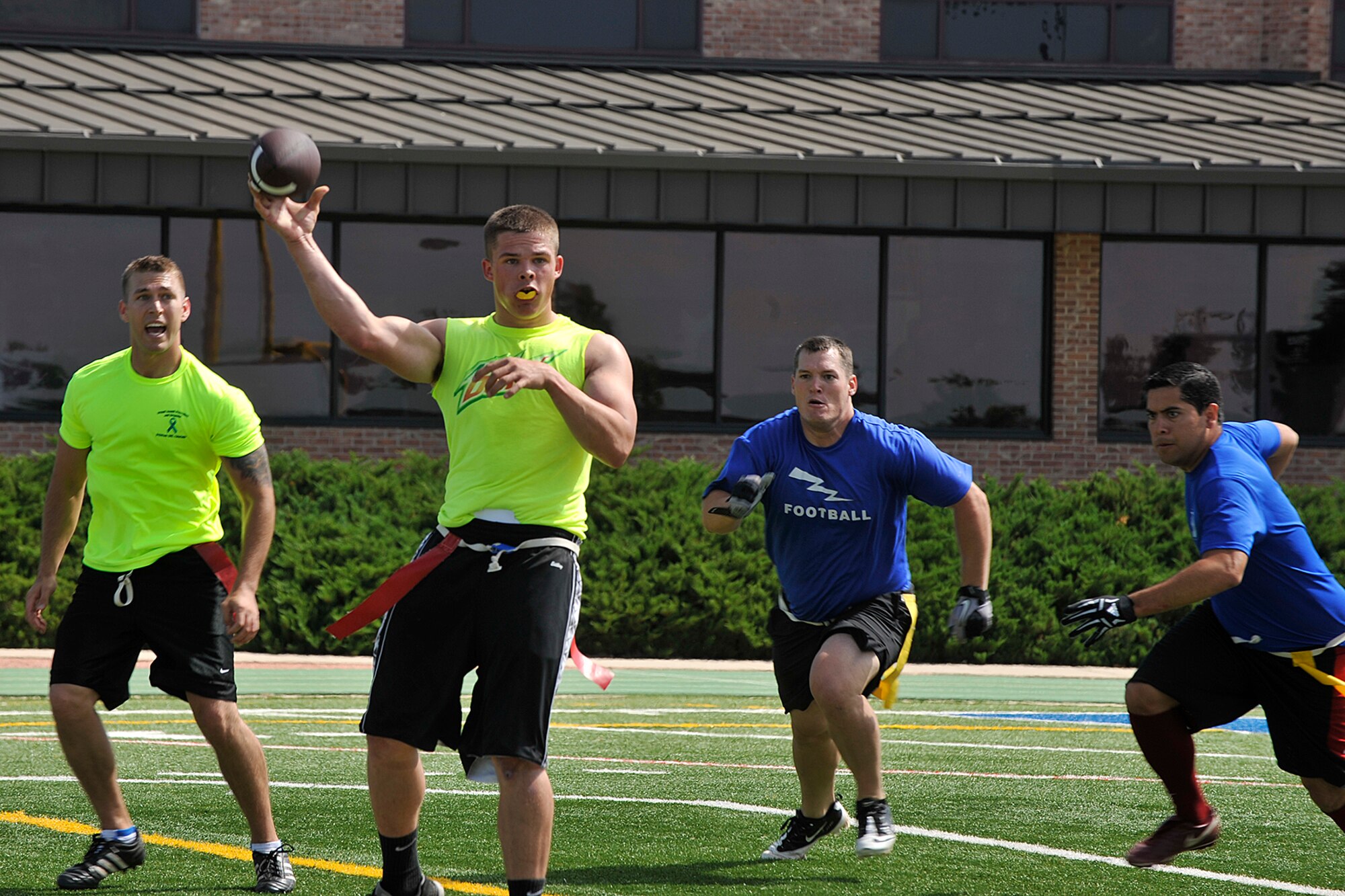 PETERSON AIR FORCE BASE, Colo. -- Peterson Air Force Base and Schriever Air Force Base compete in a football game during the first-ever Tri-Wing Sports Challenge Aug. 27 hosted by Peterson Air Force Base. The Tri-Wing Sports Challenge was an opportunity for Airmen from Buckley AFB, Peterson AFB and Schriever AFB to strengthen the bonds of camaraderie in an environment outside of the workplace. (U.S. Air Force Photo/Dennis Howk)