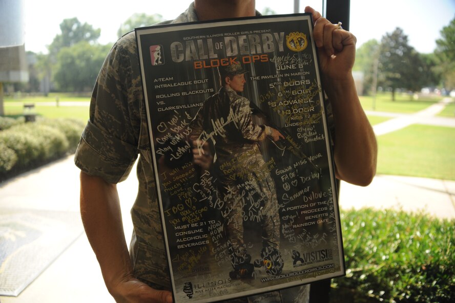 Lt. Col. Melanie Friedman, Curtis E. Lemay Center for Doctrine Development and Education deputy director of intelligence, holds up her going-away gift from her pervious roller derby team Aug. 12, 2014. Friedman played roller derby when she commanded the University of Southern Illinois Reserve Officer Training Corps in Carbondale, Ill. Now stationed at Maxwell Air Force Base, Ala., she is a utility player for the Capitol City Rollin’ Rebels. (U.S. Air Force photo by Staff Sgt. Natasha Stannard)