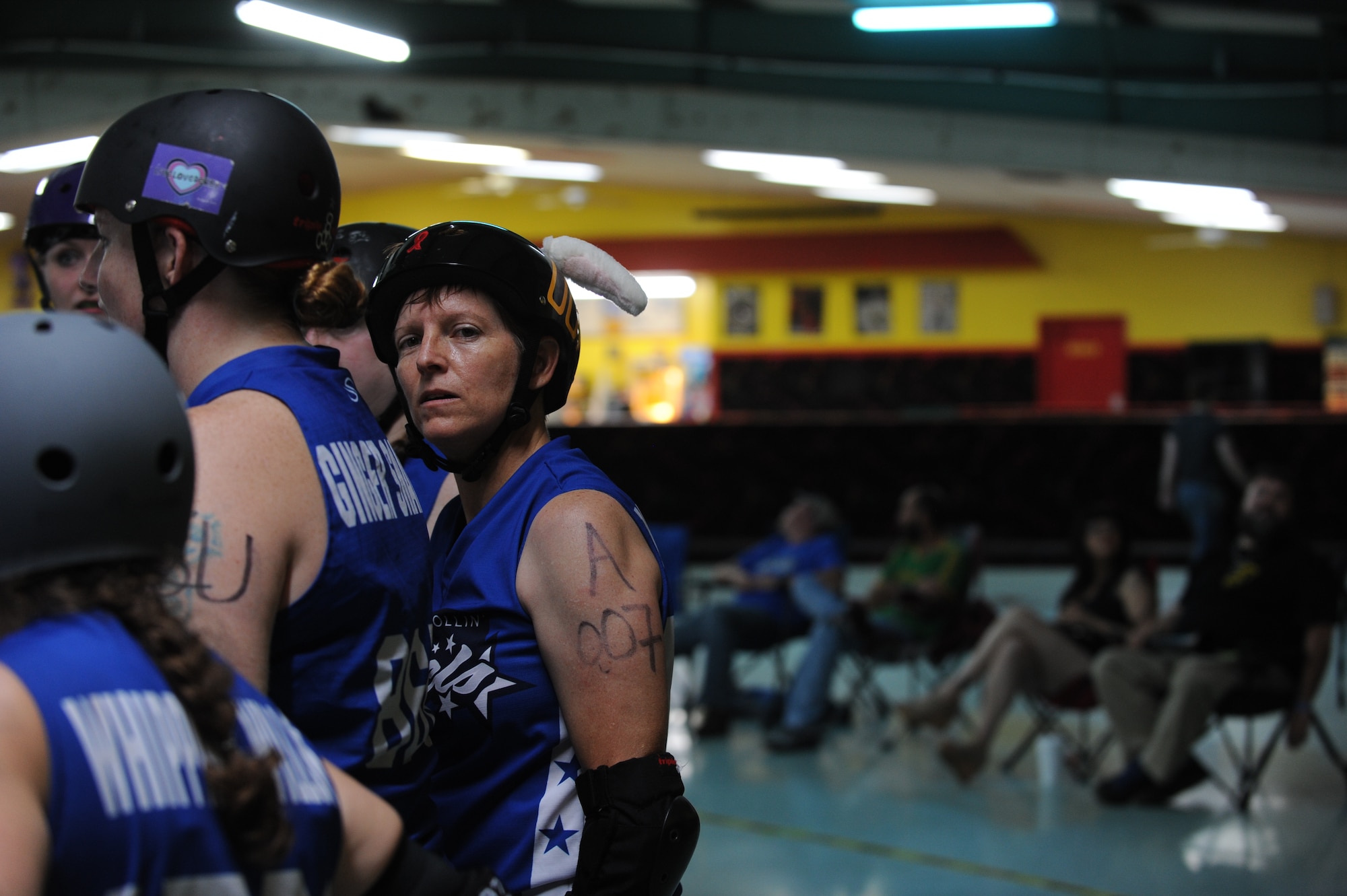 Lt. Col. Melanie Friedman, Curtis E. Lemay Center for Doctrine Development and Education deputy director of intelligence, enters a post-bout huddle with her roller derby team, the Capitol City Rollin’ Rebels, Aug. 9, 2014, in Montgomery, Ala. The Rebels won against the Mobile Derby Darlins’ 190-75. (U.S. Air Force photo by Staff Sgt. Natasha Stannard)