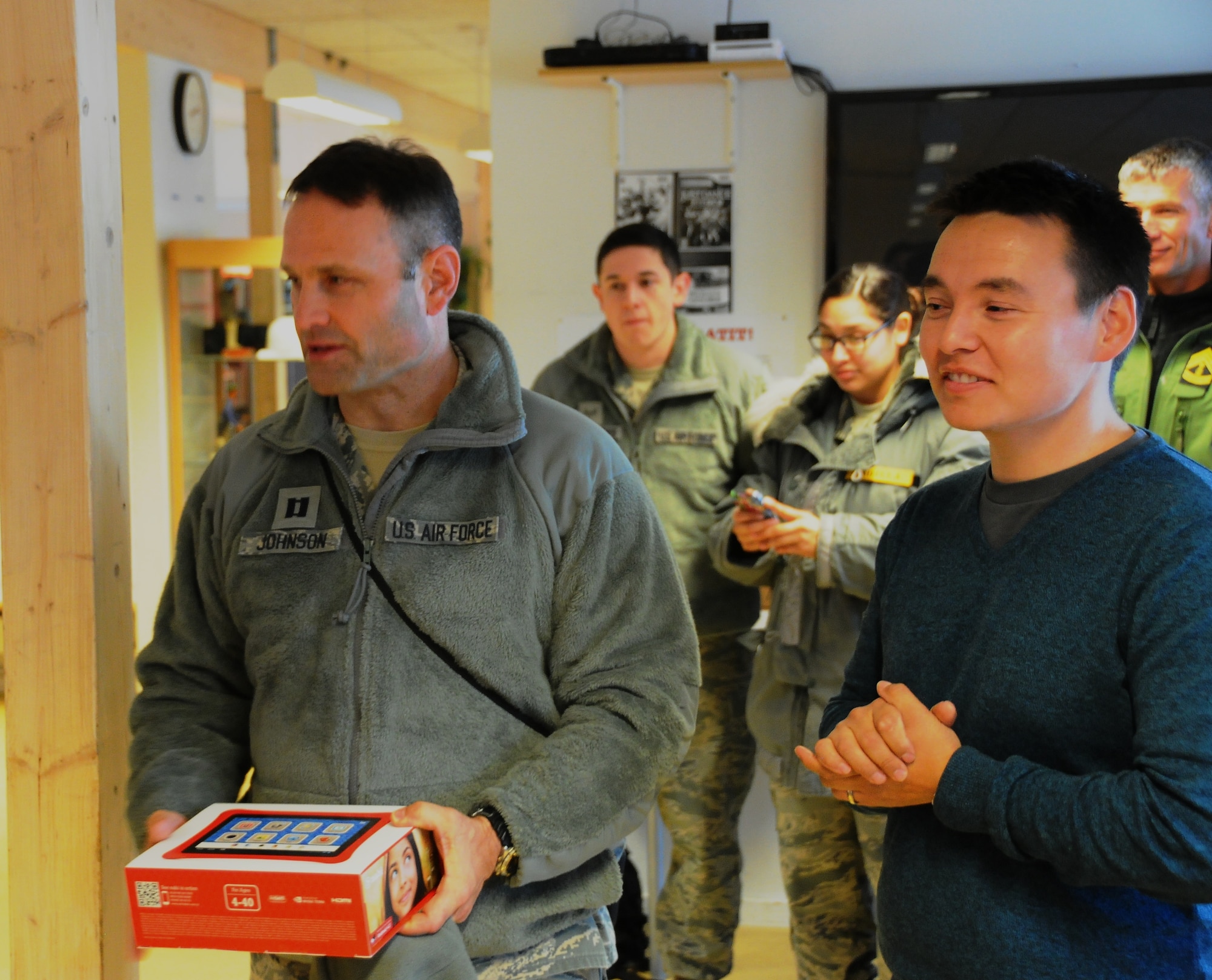 QAANAAQ VILLAGE, Greenland – Chaplain (Capt.) Michael Johnson, 821st Air Base Group chaplain, delivers educational tablets to the Qaanaaq Community School Aug. 27 near Thule Air Base. The donation was part of Thule’s annual Operation Julemand community service project. Senior Airman Zarah Padilla and Senior Airman Chad Friedrics (pictured in background), are the committee members largely responsible for the fundraising to purchase the tablets. Thule Air Base is one of the six installations operated by the 21st Space Wing. (U.S. Air Force photo/Master Sgt. Shawn Harvey)