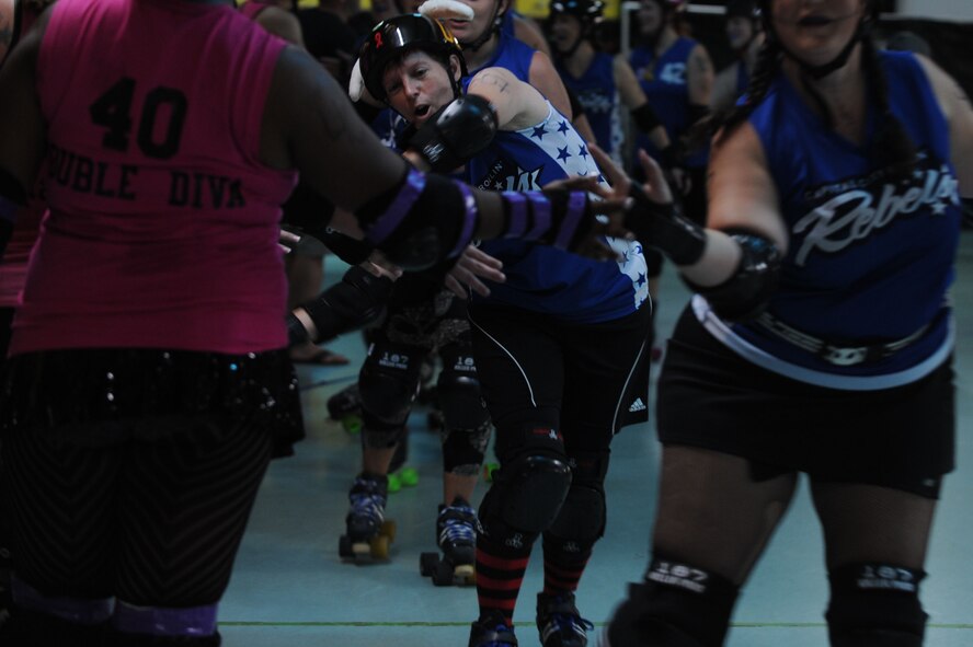 Lt. Col. Melanie Friedman, a utility player for the Capitol City Rollin’ Rebels, celebrates her roller derby team’s victory against the Mobile Derby Dalins’ Aug. 9, 2014, in Montgomery, Ala. Friedman works at Maxwell Air Force Base as the Curtis E. Lemay Center for Doctrine Development and Education deputy director of intelligence. (U.S. Air Force photo by Staff Sgt. Natasha Stannard)
