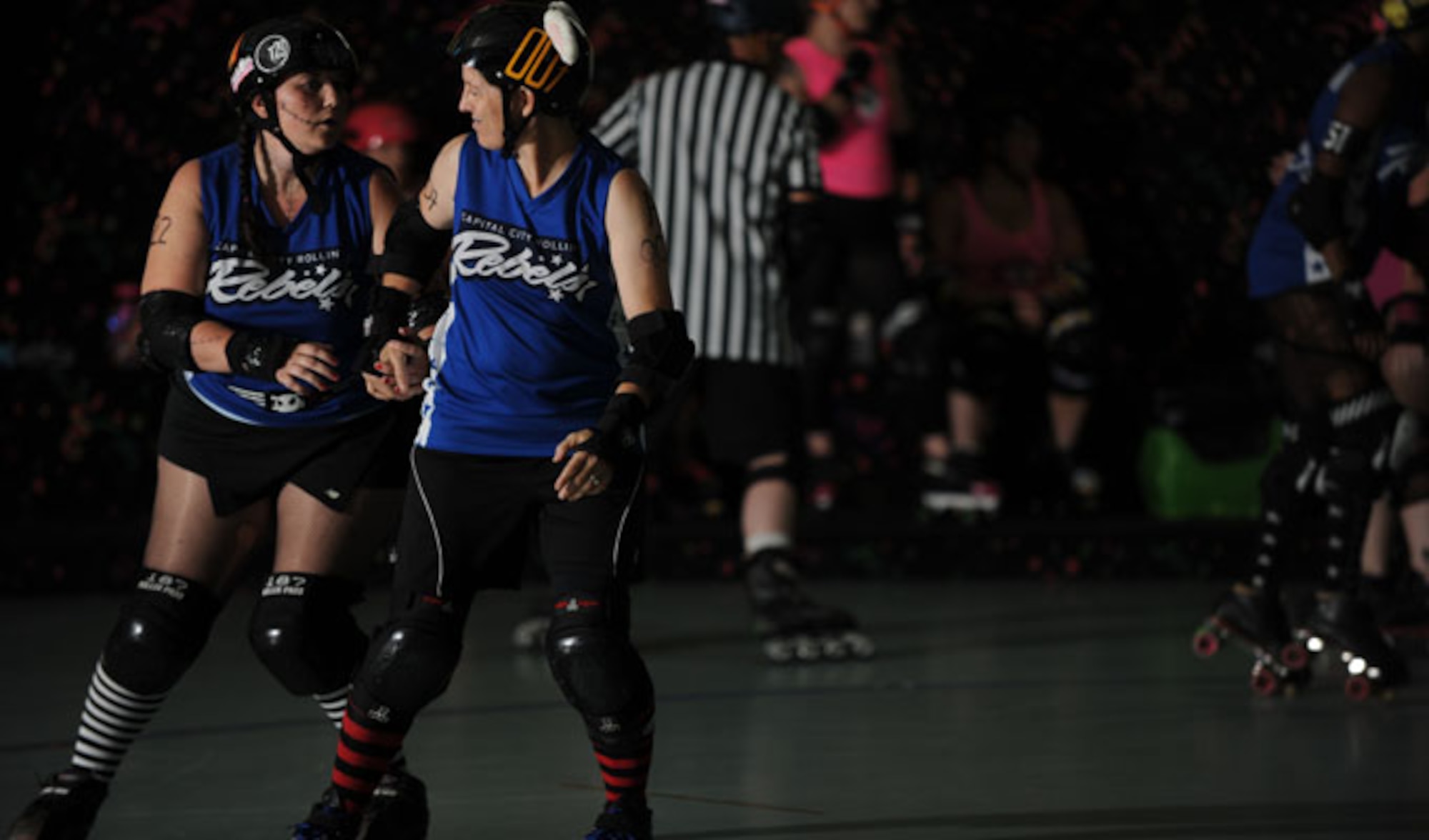 Lt. Col. Melanie Friedman, Curtis E. Lemay Center for Doctrine Development and Education deputy director of intelligence, warms-up and goes over strategy with a teammate before the Capitol City Rollin’ Rebels and Mobile Derby Darlins’ roller derby bout August 9, 2014. Friedman is an Albuquerque, N.M, native, and graduated from the University of New Mexico with a degree in political science. (U.S. Air Force photo by Staff Sgt. Natasha Stannard)