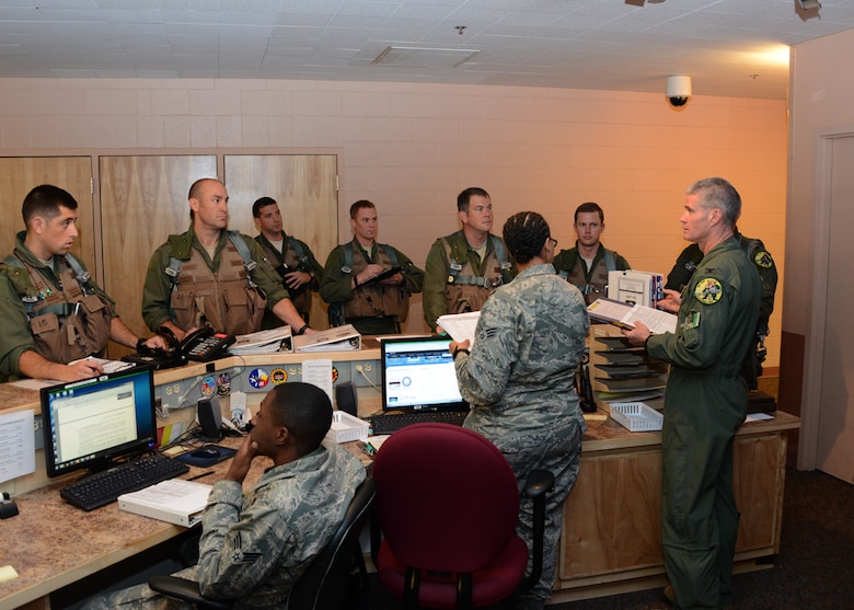 Col. Paul Johnson (right), 175th Operations Group commander, Maryland Air National Guard, Baltimore, Md. gives a pre-flight briefing to pilots from the 104th Fighter Squadron, Baltimore, Md. during Exercise Red Flag - Alaska 14-3, Eielson Air Force Base, Ak. Exercise Red Flag is a 10 day exercise that is a series of Pacific Air Forces commander-directed field training exercises for U.S. forces, provides joint offensive counter-air, interdiction, close air support, and large force employment training in a simulated combat environment. (Air National Guard photo by Tech. Sgt. Christopher Schepers/RELEASED)