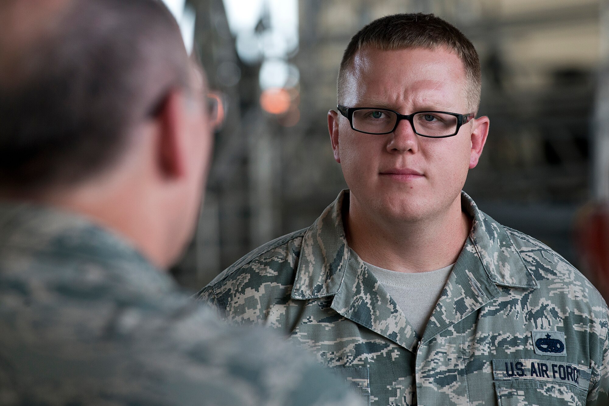 U.S. Air Force Master Sgt. Donald Ballard, 707th Maintenance Squadron weapons loader, listens to Lt. Gen. James Jackson, Commander of Air Force Reserve Command, during a tour on Aug. 26, 2014, Barksdale Air Force Base, La. Jackson's visit to Barksdale included a tour of the 307th Bomb Wing and then attending the Air Reserve Component Focus Day, which was hosted by the Air Force Global Strike Command. (U.S. Air Force photo by Master Sgt. Greg Steele/Released)