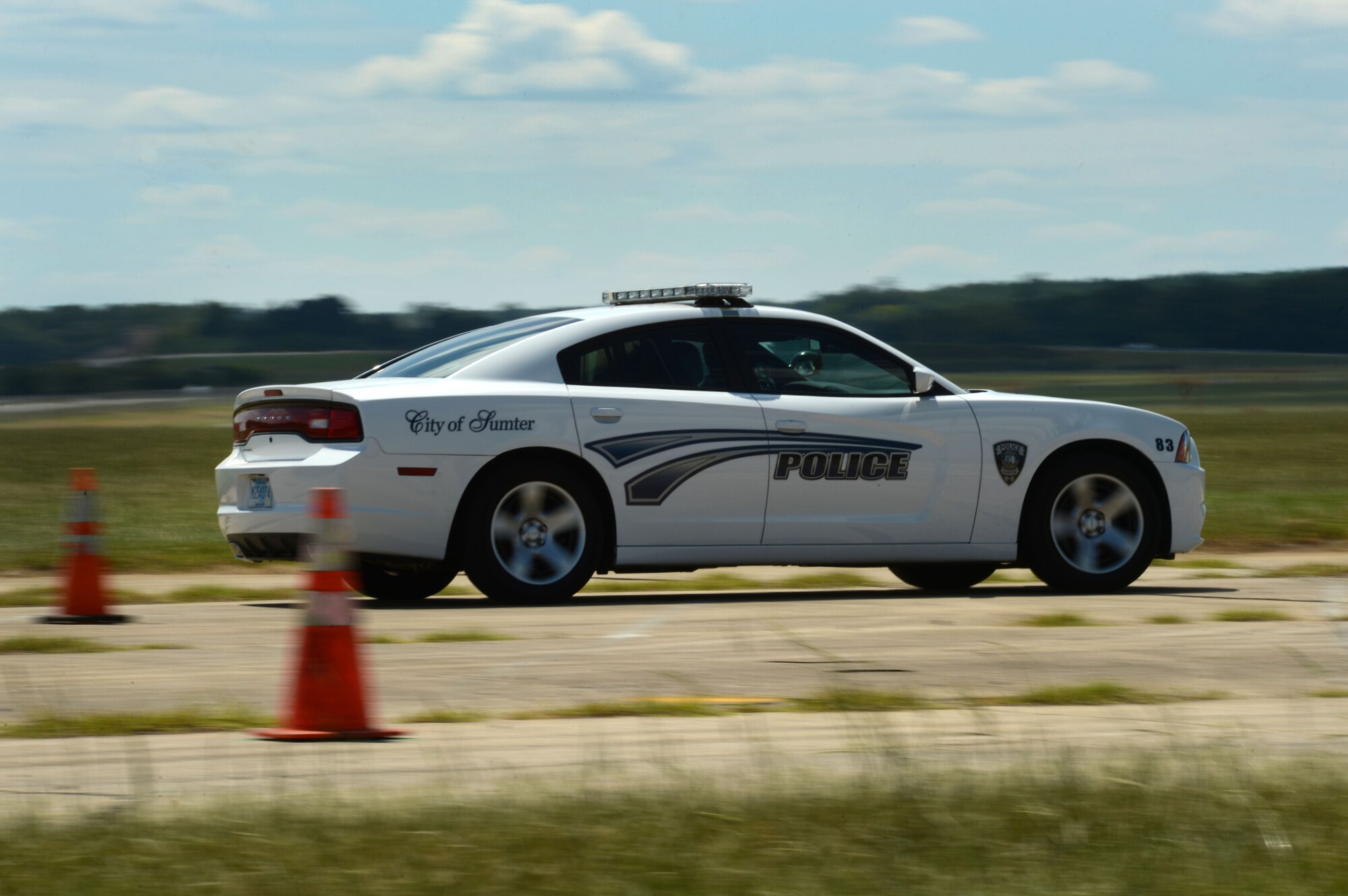 A Sumter Police Department patrol vehicle passes through cones while completing a defensive driving course at Shaw Air Force Base, S.C., Aug. 26, 2014. Throughout the course, officers maneuvered their vehicles around approximately 75 traffic cones using various speeds. (U.S. Air Force photo by Airman 1st Class Jensen Stidham/Released) 