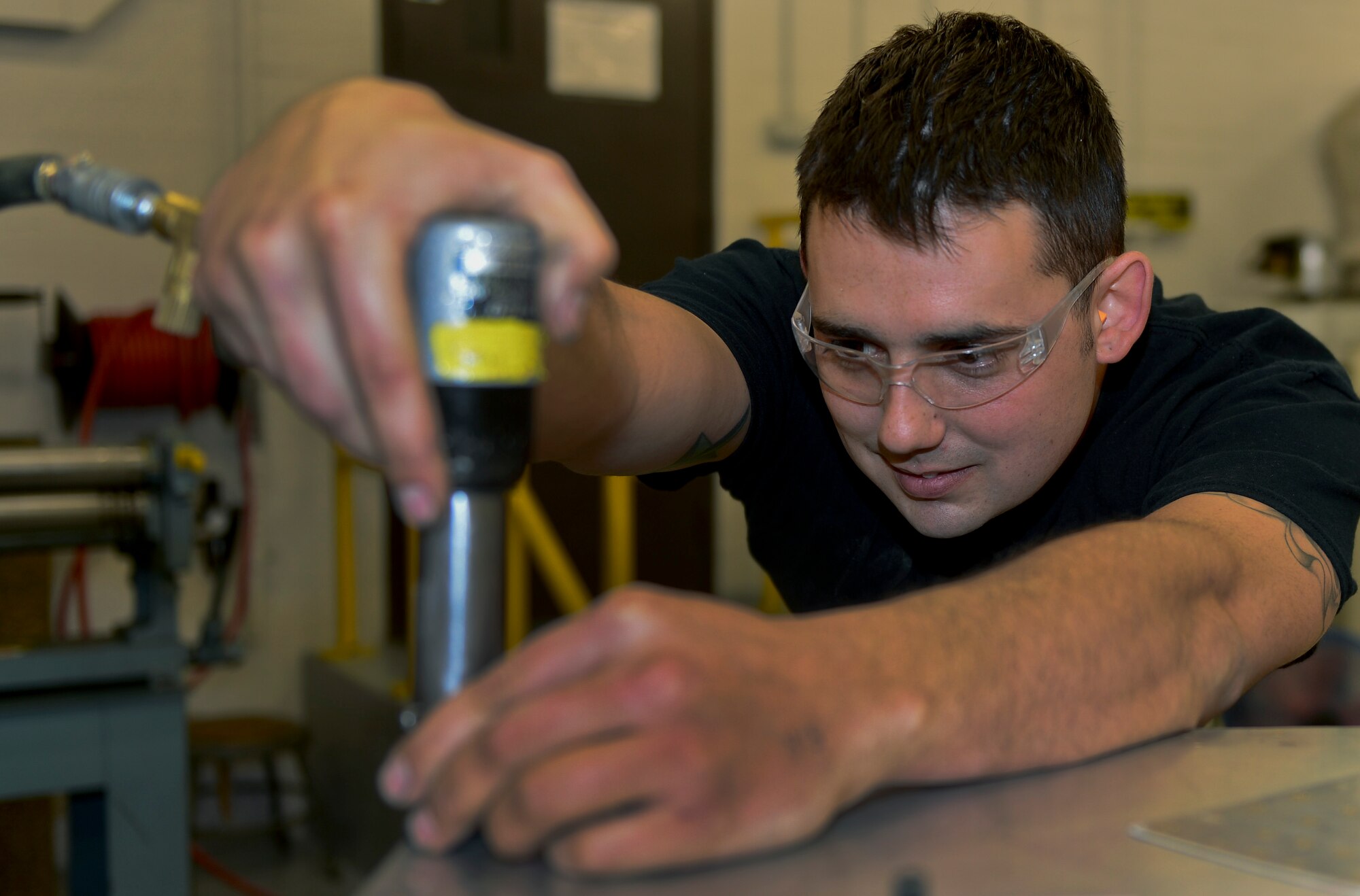 Staff Sgt. Christopher Greene, 48th Equipment Maintenance Squadron aircraft structural maintenance supervisor, tightens metal rivets at the sheet metal shop at Royal Air Force Lakenheath, England, Aug. 29, 2014. Greene was nominated for this week’s RAF Lakenheath Liberty Spotlight because he displays the core value of Service Before Self. (U.S. Air Force photo by Airman 1st Class Erin R. Babis/Released)
