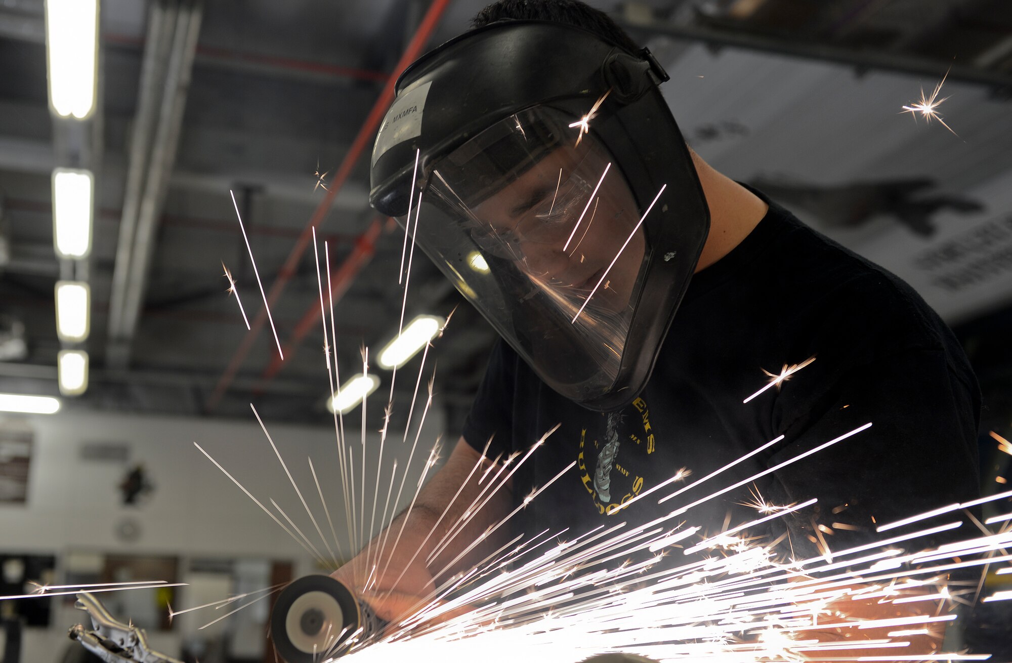 Staff Sgt. Christopher Greene, 48th Equipment Maintenance Squadron aircraft structural maintenance supervisor, cuts sheet metal at Royal Air Force Lakenheath, England, Aug. 29, 2014. Greene was nominated for this week’s RAF Lakenheath Liberty Spotlight because he displays the core value of Service Before Self. (U.S. Air Force photo by Airman 1st Class Trevor T. McBride/Released)