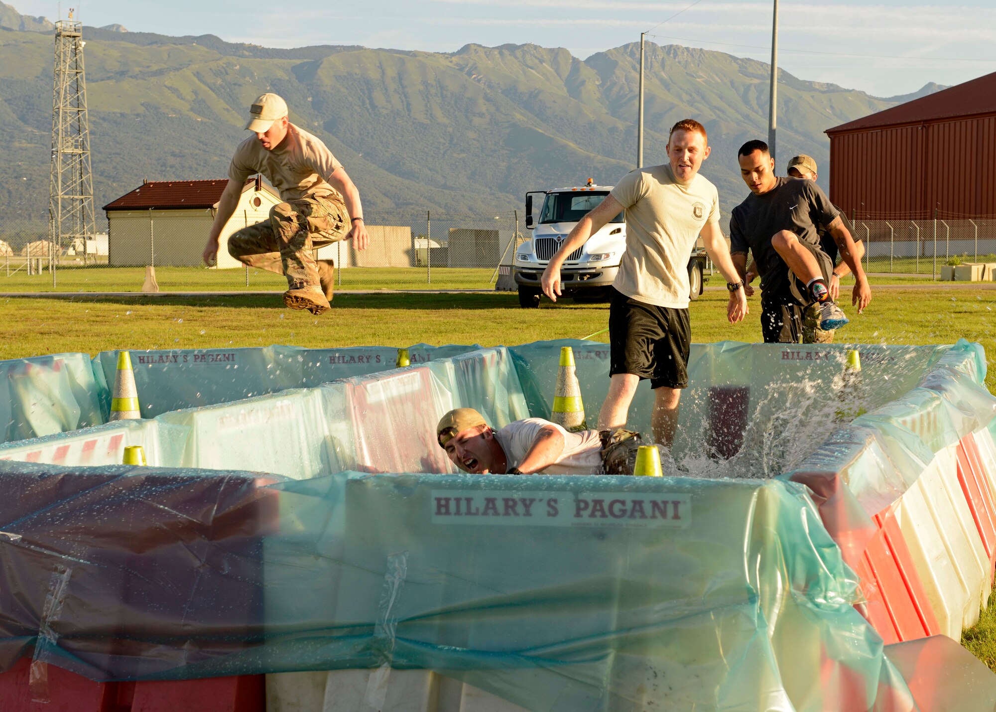 Participants enter a water obstacle during the 4th Annual Sgt. Del Toro Combat 5K, Aug. 29, 2014, at Aviano Air Base, Italy. The run was held in honor of Tech. Sgt. Israel Del Toro, a former 8th Air Support Operations Squadron member severely injured in Afghanistan in 2005. (U.S. Air Force photo/Master Sgt. Arian Nead)