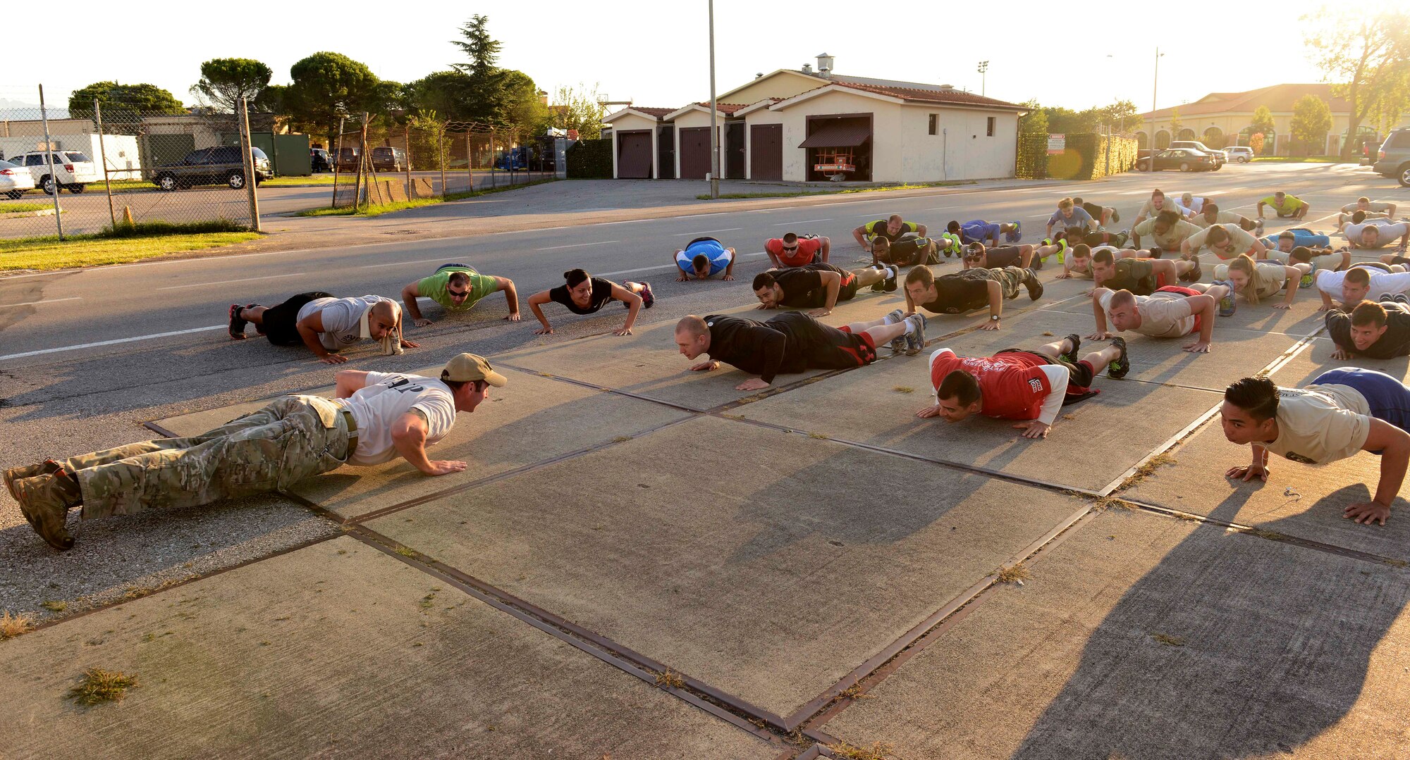 Participants perform push-ups before the 4th Annual Sgt. Del Toro Combat 5K, Aug. 29, 2014, at Aviano Air Base, Italy. More than 150 participants ran through physical fitness obstacles including water and mud as well as low crawl under Humvees. (U.S. Air Force photo/Master Sgt. Arian Nead)