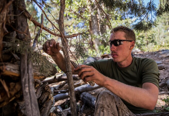 U.S. Marine Cpl. Matthew Newman ties wood together to make a survival shelter during Mountain Exercise 2014 aboard Marine Corps Mountain Warfare Training Center in Bridgeport, Calif., Aug. 28, 2014. Newman is team leader with 2nd Platoon, India Company, 3rd Battalion, 1st Marine Regiment. Marines with 3rd Battalion, 1st Marine Regiment will become the 15th Marine Expeditionary Unit’s ground combat element in October. Mountain Exercise 2014 develops critical skills the battalion will need during deployment. (U.S. Marine Corps photo by Sgt. Emmanuel Ramos/Released)
