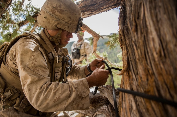 U.S. Marine Lance Cpl. Jonathan Hinojosa-Rivera secures his rappel rope to a tree during Mountain Exercise 2014 aboard Marine Corps Mountain Warfare Training Center in Bridgeport, Calif., Aug. 29, 2014. Hinojosa-Rivera is a team leader with 1st Platoon, Lima Company, 3rd Battalion, 1st Marine Regiment. Marines with 3rd Battalion, 1st Marine Regiment will become the 15th Marine Expeditionary Unit’s ground combat element in October. Mountain Exercise 2014 develops critical skills the battalion will need during deployment. (U.S. Marine Corps photo by Sgt. Emmanuel Ramos/Released)