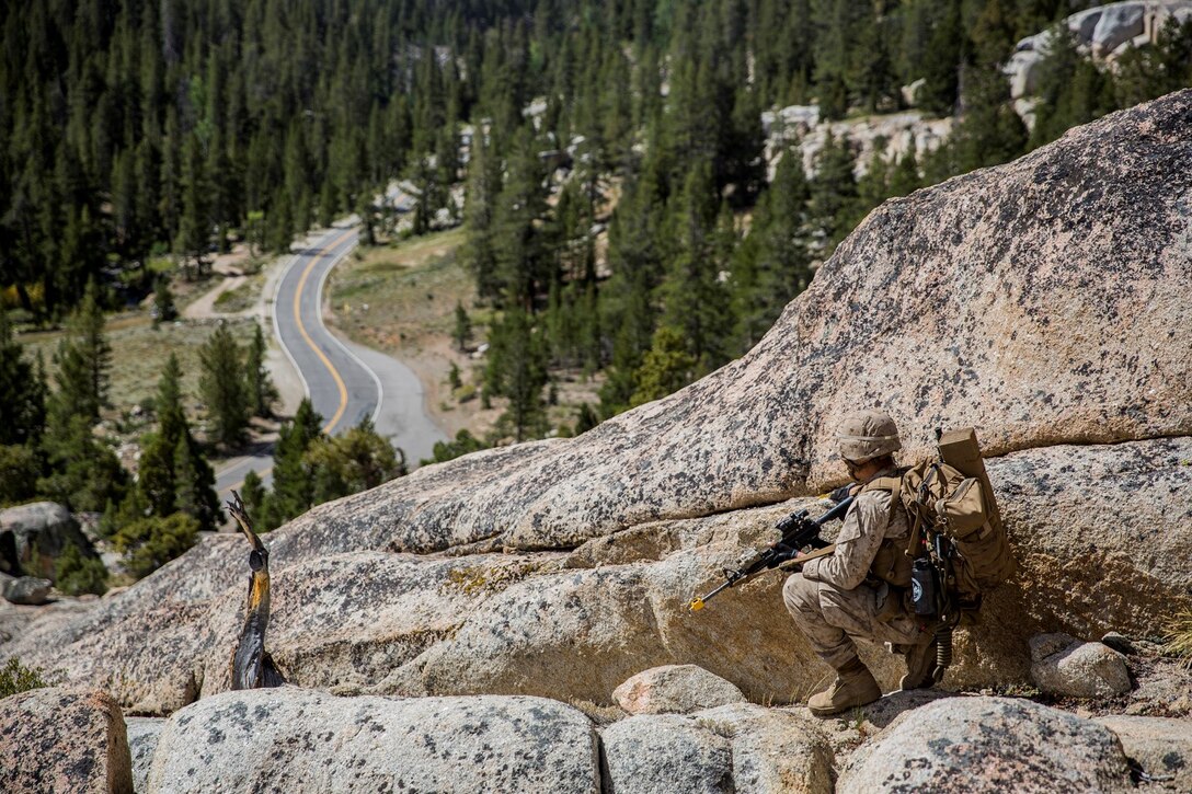 U.S. Marine Cpl. John F. Espinoza provides over-watch while Marines rappel down a cliff during Mountain Exercise 2014 aboard Marine Corps Mountain Warfare Training Center in Bridgeport, Calif., Aug. 29, 2014. Espinoza is a squad leader with 2nd Platoon, Lima Company, 3rd Battalion, 1st Marine Regiment. Marines with 3/1 will become the 15th Marine Expeditionary Unit’s ground combat element in October. Mountain Exercise 2014 develops critical skills the battalion will need during deployment. (U.S. Marine Corps photo by Sgt. Emmanuel Ramos/Released)