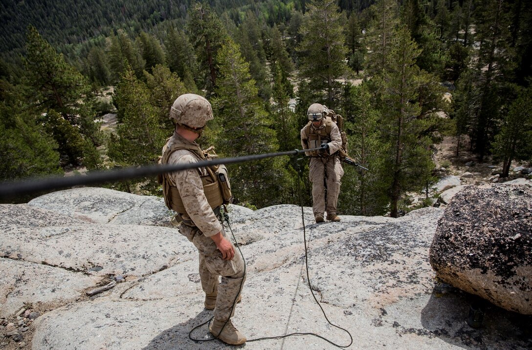 U.S. Marine Lance Cpl. Franklin Welke guides a Marine down a cliff during Mountain Exercise 2014 aboard Marine Corps Mountain Warfare Training Center in Bridgeport, Calif., Aug. 29, 2014. Welke is a team leader with 2nd Platoon, Lima Company, 3rd Battalion, 1st Marine Regiment. Marines with 3rd Battalion, 1st Marine Regiment will become the 15th Marine Expeditionary Unit’s ground combat element in October. Mountain Exercise 2014 develops critical skills the battalion will need during deployment. (U.S. Marine Corps photo by Sgt. Emmanuel Ramos/Released)