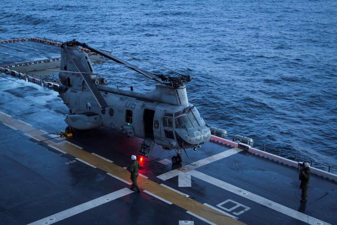 A CH-46E Sea Knight helicopter with Marine Medium Helicopter Squadron 364 lands on the flight deck of the future amphibious assault ship USS America (LHA 6), Aug. 24, 2014. Four helicopters with the squadron arrived aboard America ending the exercise Partnership of the Americas 2014. POA was based on a simulated humanitarian assistance and disaster relief scenario in Chile. Multiple nations came together to plan and execute a multi-lateral exercise in response to the HA/DR scenario. Exercises like POA allow the U.S. and our partners in the region to respond to and address transnational and global challenges. America is currently transiting through the U.S. Southern Command’s area of responsibility on her maiden transit “America Visits the Americas.” (U.S. Marine Corps Photo by Cpl. Donald Holbert/ Released)