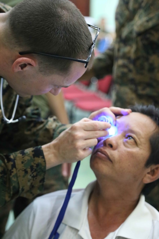 Lt. Cmdr. Anthony Bielawski, a doctor with Combat Logistics Battalion 11, 11th Marine Expeditionary Unit treats a Malaysian patient during a medical and dental outreach partnered with the Royal Malaysian Medical Corps as part of Malaysia-United States Amphibious Exercise 2014. During the first day of the outreach, doctors and dentists treated 159 medical and 70 dental patients. During MALUS AMPHEX 14, Marines with the 11th MEU conduct partnered training with the Malaysian Armed Forces including shipboard familiarization, medical and dental training, and weapons familiarization. (U.S. Marine Corps photo by Gunnery Sgt. Rome M. Lazarus/Released)