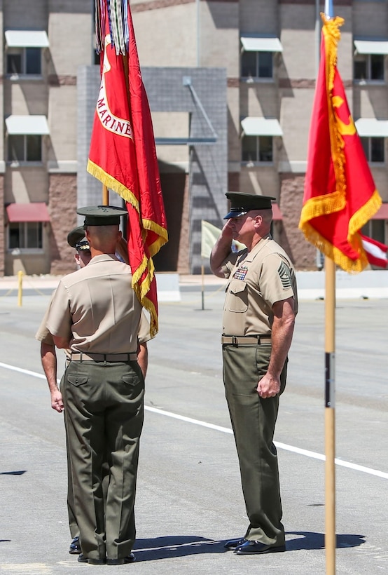 Brigadier Gen. Joaquin F. Malavet, the commanding general of 1st Marine Expeditionary Brigade, receives the unit colors from Brig. Gen. Carl E. Mundy III, the former commanding general of 1st MEB, during the 1st MEB change of command ceremony aboard Camp Pendleton, Calif., Aug. 29, 2014. Malavet was previously assigned as the principal director, South and Southeast Asia for the Office of the Secretary of Defense-Policy at Washington, D.C. (U.S. Marine Corps photo by Lance Cpl. Carson Gramley)