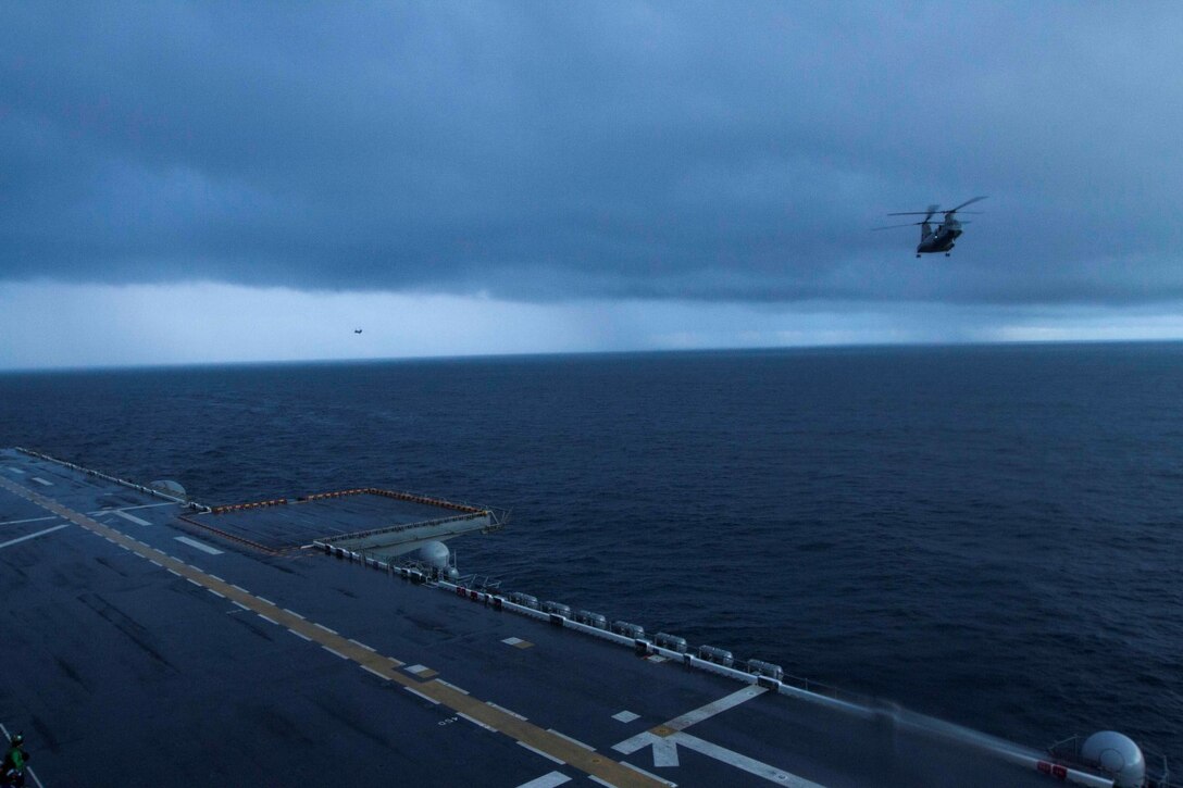 A CH-46E Sea Knight helicopter with Marine Medium Helicopter Squadron 364 approaches the flight deck of the future amphibious assault ship USS America (LHA 6) preparing to land, Aug. 24, 2014. Four helicopters with the squadron arrived aboard America ending the exercise Partnership of the Americas 2014. POA was based on a simulated humanitarian assistance and disaster relief scenario in Chile. Multiple nations came together to plan and execute a multi-lateral exercise in response to the HA/DR scenario. Exercises like POA allow the U.S. and our partners in the region to respond to and address transnational and global challenges. America is currently transiting through the U.S. Southern Command’s area of responsibility on her maiden transit “America Visits the Americas.” (U.S. Marine Corps Photo by Cpl. Donald Holbert/ Released)