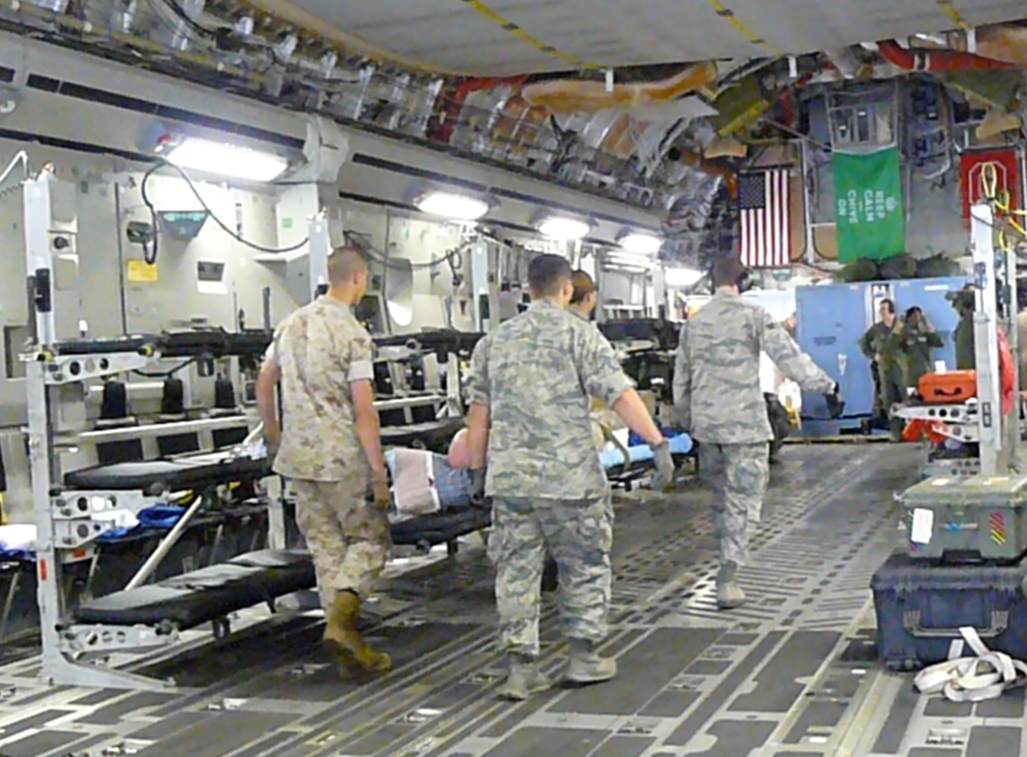 A Contingency Aeromedical Staging Facility team including six members from the 944th ASTS, Luke Air Force Base, help transport injured military members as they travel from deployed locations to their care facilities in the United States. (U.S. Air Force photo/Maj. Elizabeth Magnusson)