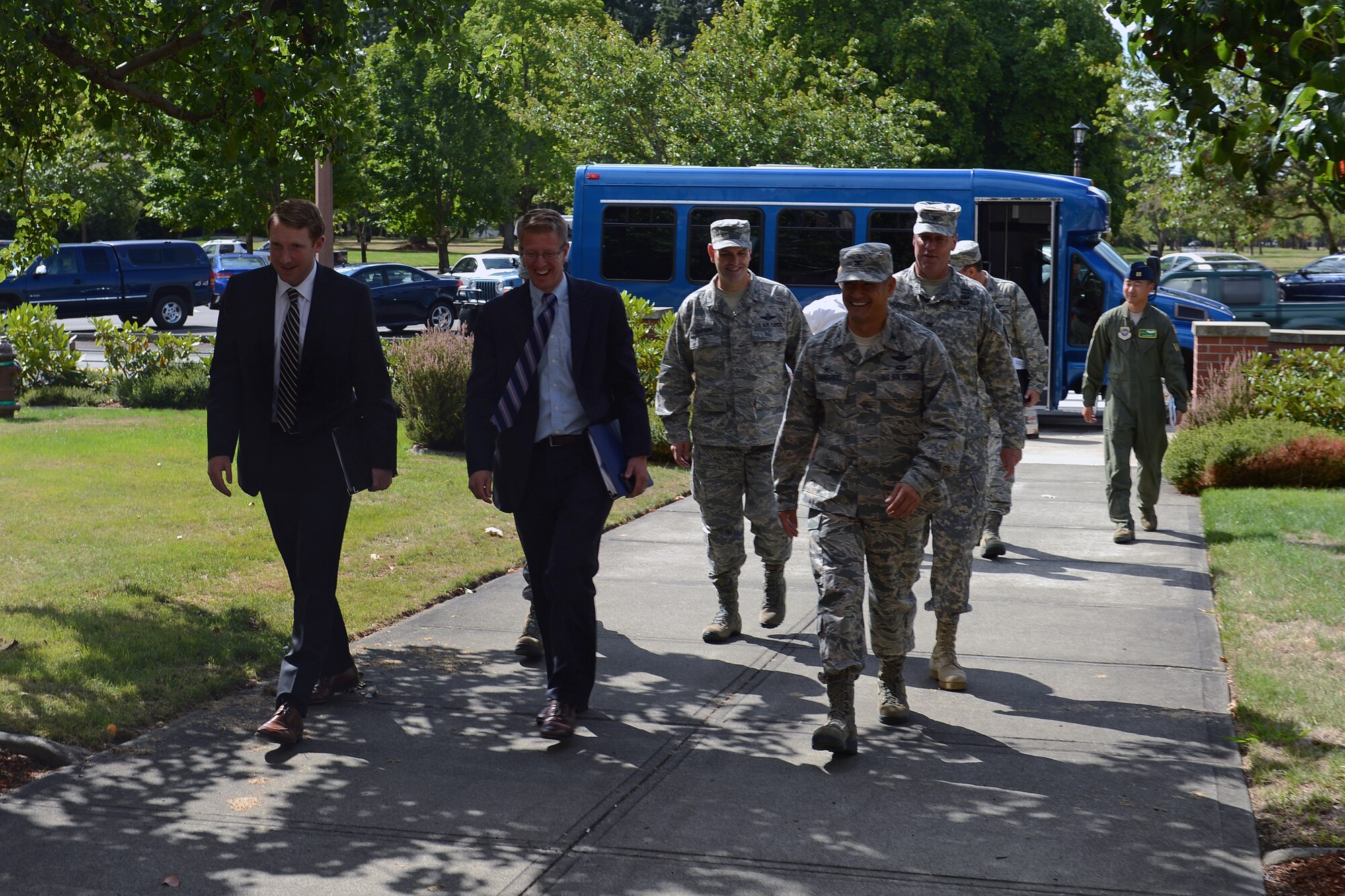 Joe Dacca (left), deputy district director, and Congressman Derek Kilmer walk with base leadership to the 62nd Airlift Wing command building during a tour Sept. 2, 2014, at Joint Base Lewis-McChord, Wash. During his visit, Kilmer also met with leadership at the I-Corps Headquarters on Lewis North. (U. S. Air Force photo/Airman 1st Class Jacob Jimenez)  