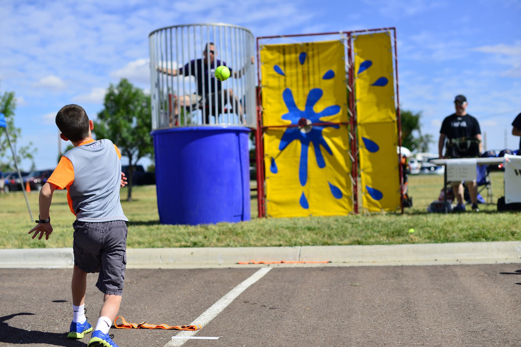 A boy takes his turn at trying to dunk Col. John Wilcox, 341st Missile Wing commander, during the base picnic at Sun Plaza Park Aug. 28. More than 4,100 Airmen, DoD civilians, retirees and family members showed up at the park to enjoy some sun, food and fun during the base picnic. (U.S. Air Force photo/Tech. Sgt. Chad Thompson)