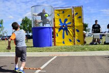 A boy takes his turn at trying to dunk Col. John Wilcox, 341st Missile Wing commander, during the base picnic at Sun Plaza Park Aug. 28. More than 4,100 Airmen, DoD civilians, retirees and family members showed up at the park to enjoy some sun, food and fun during the base picnic. (U.S. Air Force photo/Tech. Sgt. Chad Thompson)