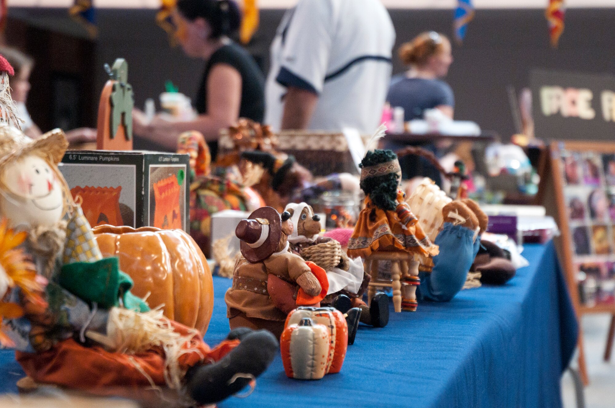 An assortment of fall items awaits sale by Mary Kuschel, wife of Maj., retired, William Kuschel, at a flea market in the Fall Hall Community Center Aug. 30, 2014. (U.S. Air Force photo by Airman Malcolm Mayfield)