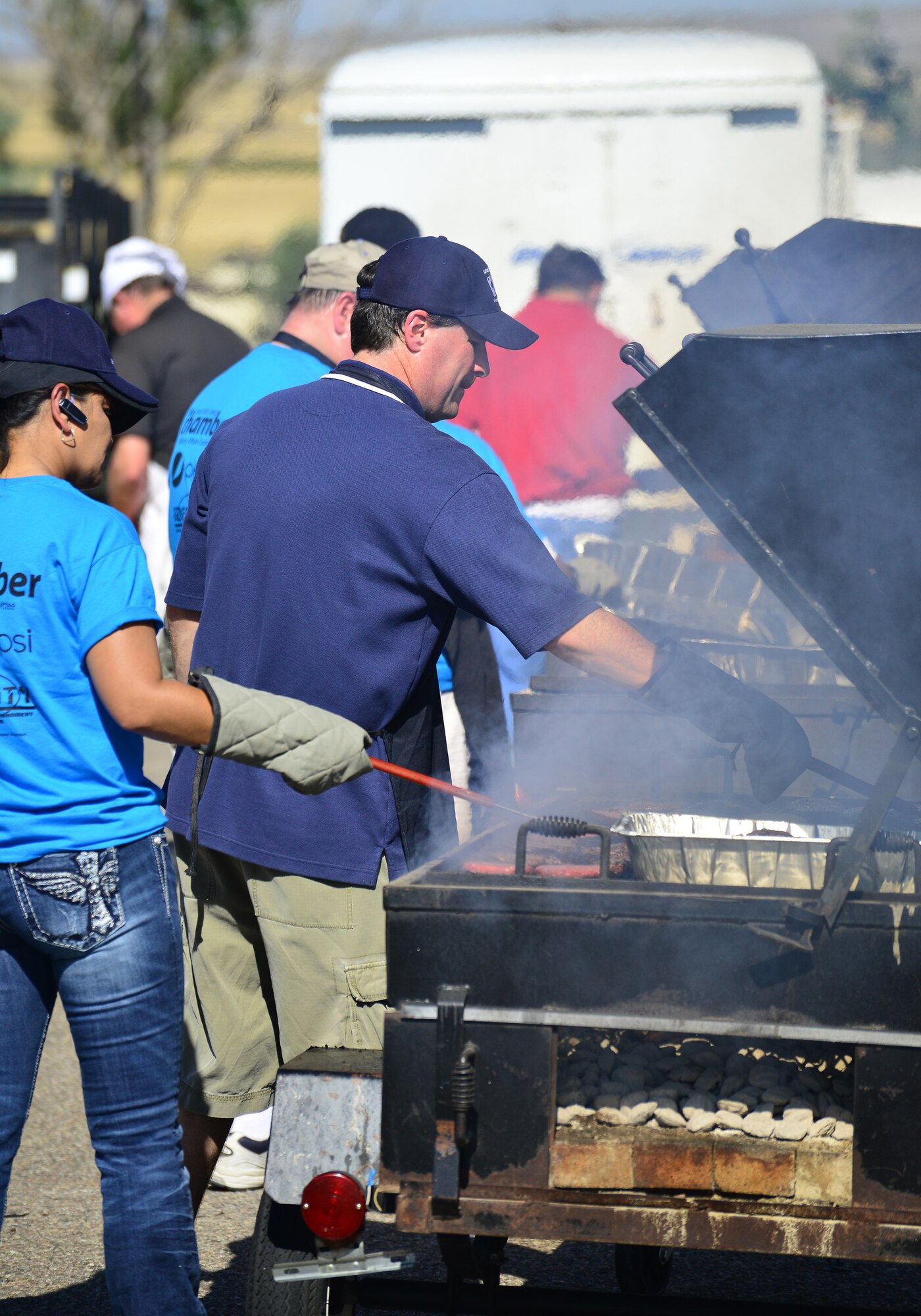 Volunteers with the Military Affairs Committee and Great Falls Chamber of Commerce work the grills at Sun Plaza Park during the base picnic Aug. 28. More than 4,100 Airmen, DoD civilians, retirees and family members showed up at the park to enjoy some sun, food and fun during the base picnic. (U.S. Air Force photo/Tech. Sgt. Chad Thompson)