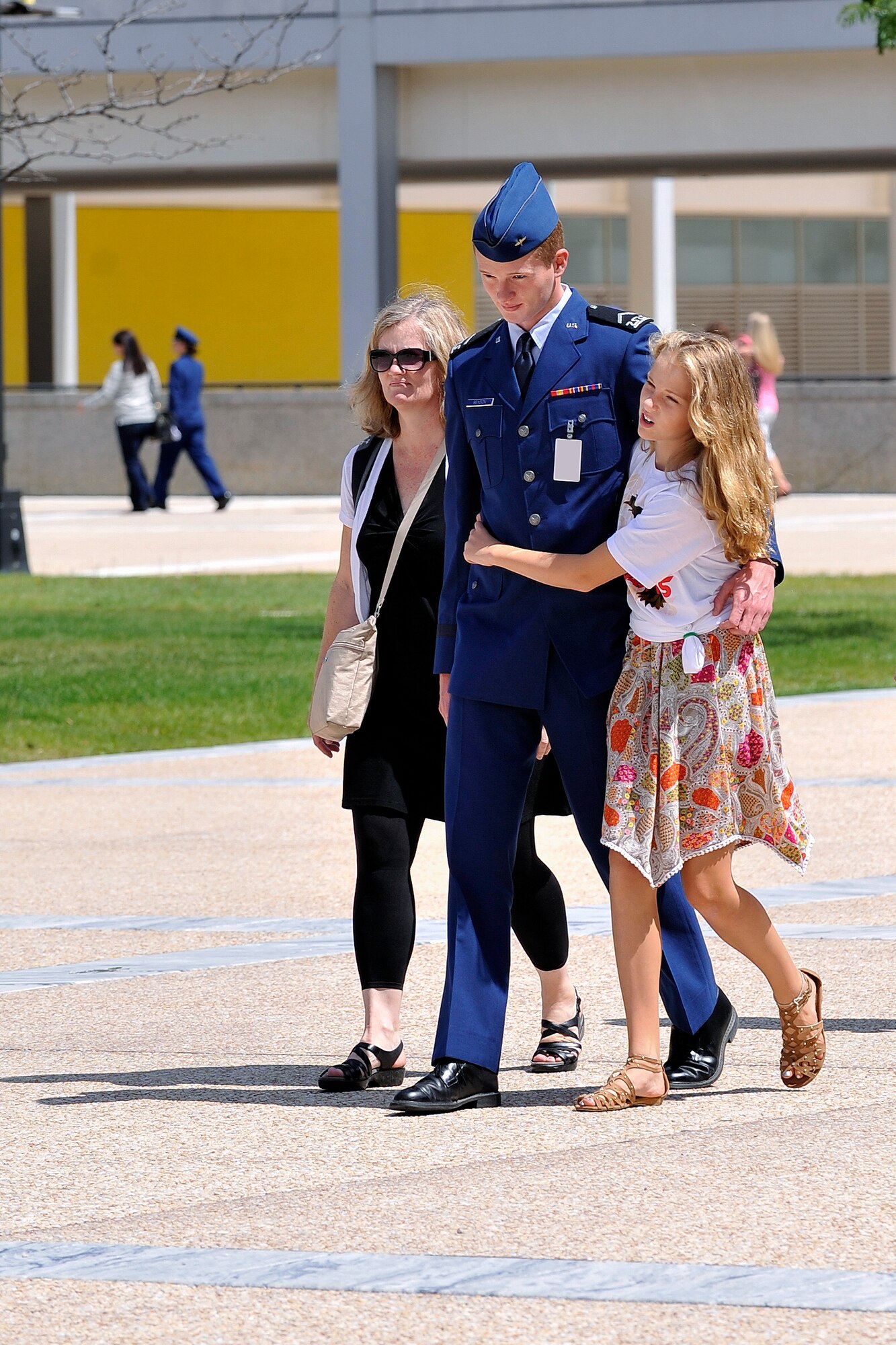 An Academy cadet walks with family members here during Parents' Weekend, Aug. 29 - Sept. 1. Parents' Weekend is an annual Academy event held Labor Day weekend to allow cadets' parents and family members to experience part of cadet life. (U.S. Air Force photo/Liz Copan)
