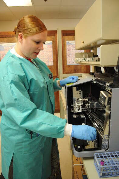 U.S. Air Force Tech. Sgt. Heather Whitted, 7th Medical Support Squadron laboratory non-commissioned officer in charge, places a test tube sample of blood into a Hematology Analyzer Aug. 22, 2014, at the medical center on Dyess Air Force Base, Texas. This analyzer is used to count the number of red and white blood cells within a sample. (U.S. Air Force photo by Senior Airman Shannon Hall/Released)