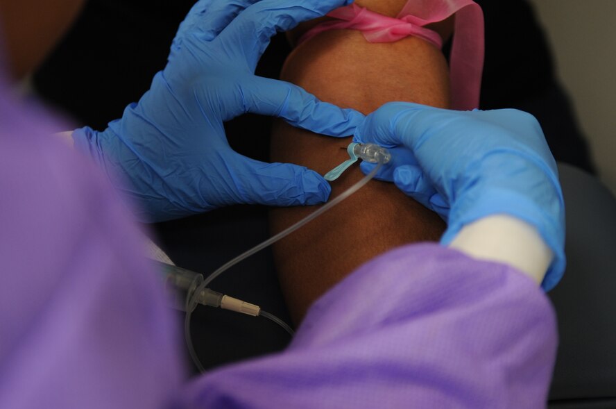 A lab technician uses a butterfly needle to withdraw blood from a patient Aug. 22, 2014, at the medical center on Dyess Air Force Base, Texas. Lab technicians assigned to the 7th Medical Support Squadron here help keep Airmen healthy by conducting different tests assigned by their primary care physician to help determine the correct diagnosis. (U.S. Air Force photo by Senior Airman Shannon Hall/Released)