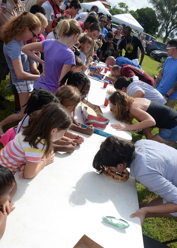 Spectators of all ages observe the pie eating contest at the 2014 Labor Day Bash Sept. 1, 2014, on Andersen Air Force Base, Guam. The annual event featured a dance contest, a water balloon fight and carabao rides. (U.S. Air Force photo by Senior Airman Katrina M. Brisbin/Released) 