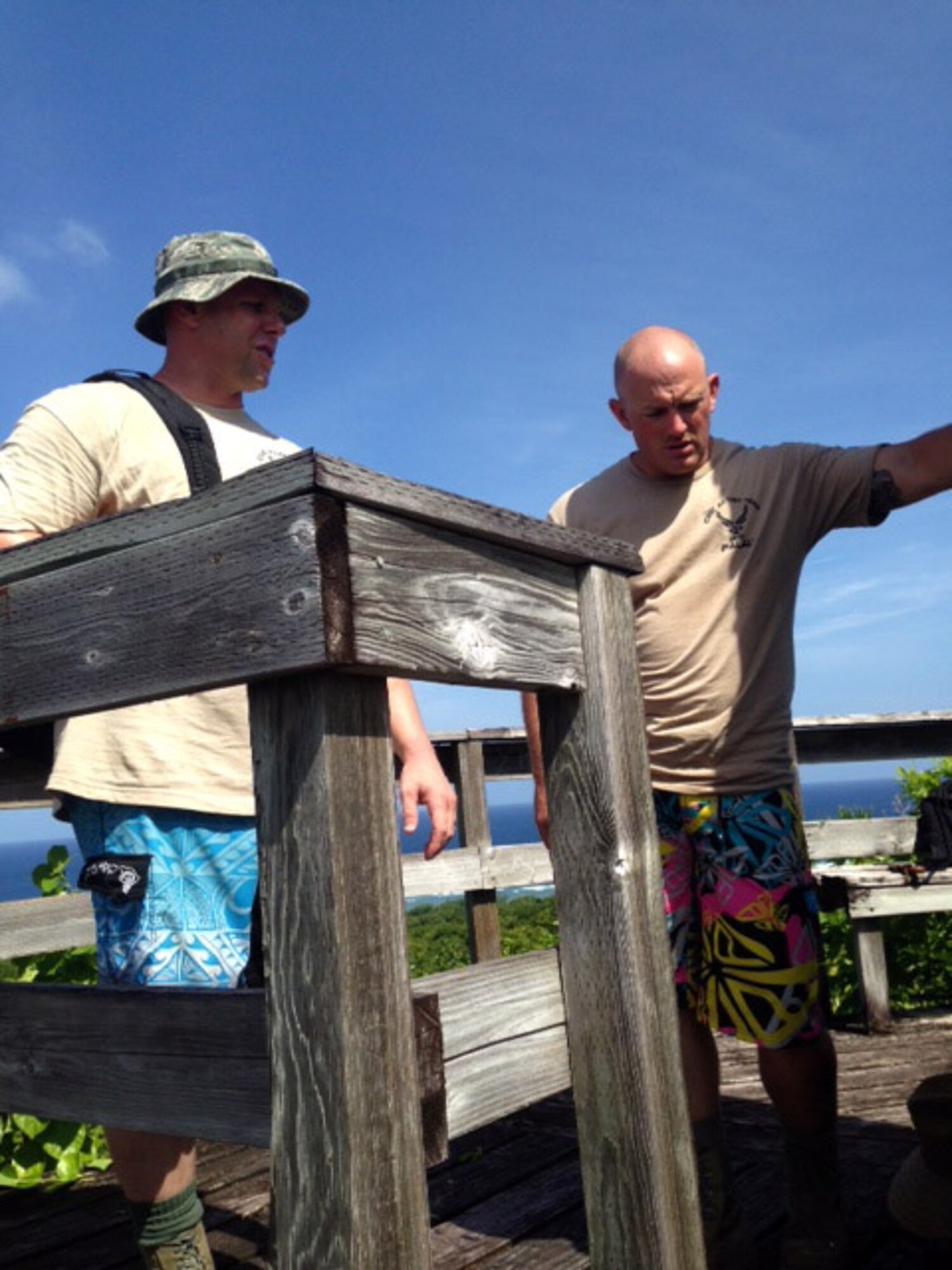 U.S. Air Force Master Sgt. Bryan Rosburg and Tech. Sgt. Gerald Bontrager, Civic Action Team-Palau members, survey the condition of the deck before restoration of the Bloody Nose Ridge Memorial Deck, Peleliu, Republic of Palau. The CAT-Palau team consisted of 13 Airmen and 13 Palauan apprentices who worked over eight days to complete the project. (Courtesy photo/Released)