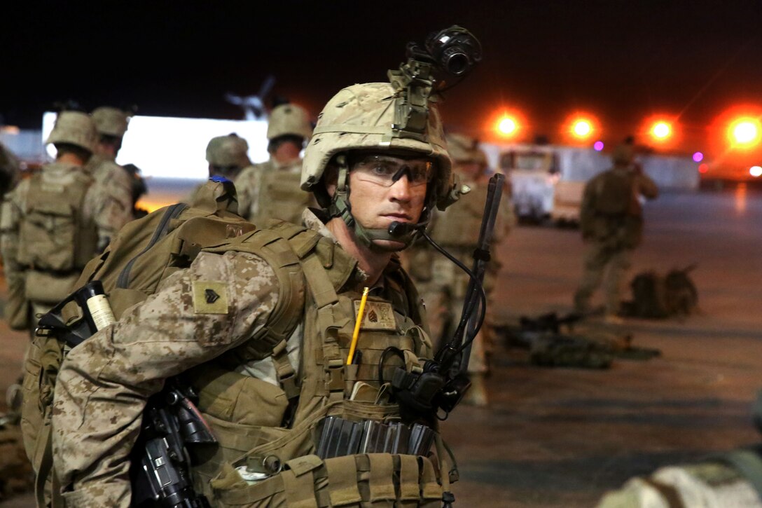 U.S. Marine Corps Sgt. Warren Sparks prepares his gear before loading onto a CH-53E Super Stallion helicopter on Camp Leatherneck for a mission in Helmand province, Afghanistan, Aug. 18, 2014. Sparks is a squad leader assigned to Bravo Company, 1st Battalion, 7th Marine Regiment.