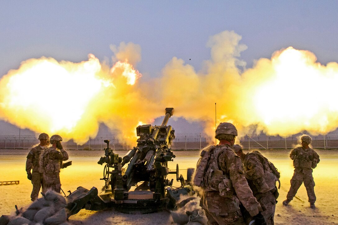 U.S. soldiers fire a round down range from their M777A2 howitzer on Kandahar Airfield, Afghanistan, Aug. 22, 2014. The soldiers are assigned to the 4th Infantry Division's 2nd Battalion, 77th Field Artillery Regiment, 4th Infantry Brigade Combat Team. The round was part of a shoot to register the howitzer, which had just arrived on the airfield from Forward Operating Base Pasab.