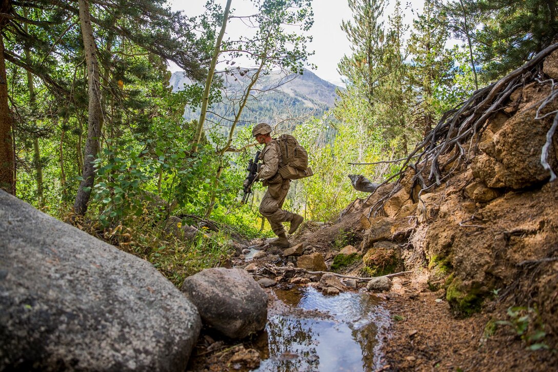 U.S. Marine Lance Cpl. Jona Moore tactically makes his way through the mountainous terrain with his squad during Mountain Exercise 2014 aboard Marine Corps Mountain Warfare Training Center in Bridgeport, Calif., Aug. 29, 2014. Moore is a team leader with 3rd Platoon, Lima Company, 3rd Battalion, 1st Marine Regiment. Marines with 3rd Battalion, 1st Marine Regiment will become the 15th Marine Expeditionary Unit’s ground combat element in October. Mountain Exercise 2014 develops critical skills the battalion will need during deployment. (U.S. Marine Corps photo by Sgt. Emmanuel Ramos/Released)