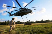 A CH-53E Super Stallion helicopter with Marine Heavy Helicopter Training Squadron 302, Marine Aircraft Group 29, 2nd Marine Air Wing, lifts off after Marines from Helicopter Support Team, Combat Logistics Battalion 26, 2nd Marine Logistics Group connected a metal beam during external lift training aboard Camp Lejeune, N.C., Aug. 27, 2014. Marines with CLB-26 partnered with HMHT-302 to practice single and dual point cargo lifts.