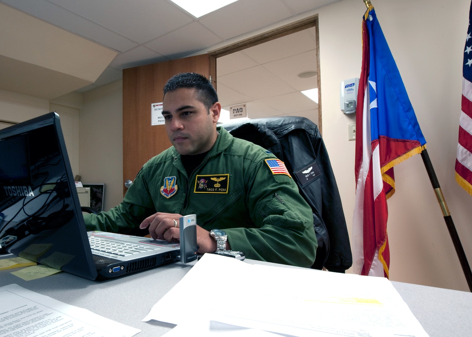 1st Lt. Tirso Peña, a navigator assigned to the Puerto Rico Air National Guard's 156th Airlift Squadron, monitor a chat room at the Puerto Rico National Guard joint operations center in San Juan, P.R. Multiple military units use the chat room to transmit information about the Haitian earthquake relief efforts. Peña said the JOC is relaying this information to Army aviation units on the ground in the Dominican Republic.