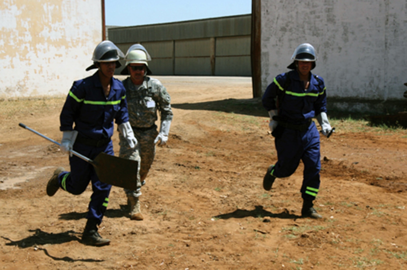 Master Sgt. Ron Moody of the Utah National Guard works with Moroccan firefighters, running fire hoses and hooking up to a fire truck during a recent training event in Rabat, Morocco.