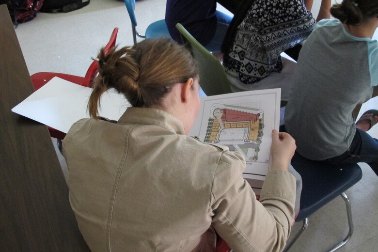 A student at the Academy of Academics and Art examines an architectural drawing during STEM discussion August 28.