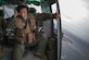 Maj. Zensaku Munn listens to the radio Aug. 31, 2014, during the Shizuoka Comprehensive Disaster Drill over Shimoda bay, Japan. Munn relayed drop clearance to the inbound C-130 Hercules from a UH-1N Iroquois during the drill. Munn is a 374th Operations Support Squadron air mobility liaison officer. (U.S. Air Force photo/Osakabe Yasuo) 