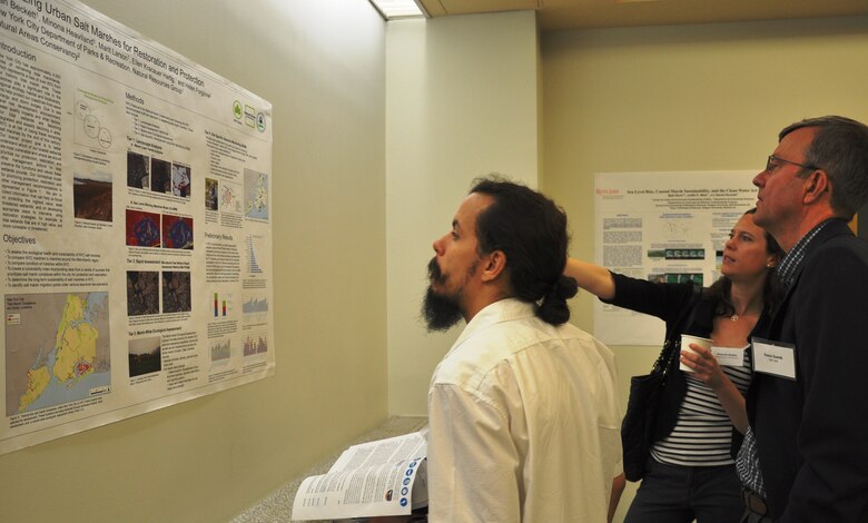 Participants at a major environmental symposium in New York City study a display outlining salt marsh restoration. The symposium, “Restoring the New York-New Jersey Harbor Estuary: Ensuring Ecosystem Resilience and Sustainability in a Changing Future,” was held June 3, 2014 in Manhattan, attracted more than 200 scientists, engineers, academics and restoration professionals discussing progress and new initiatives to restore the Estuary.