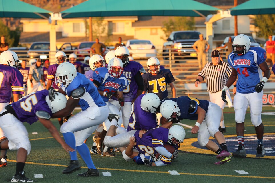 Marines with Marine Wing Support Squadron 374 and Marine Corps Communication-Electronics School go head-to-head for the first time during the Preseason Jamboree at Felix Field, Aug. 27, 2014. Intramural tackle football is scheduled to be hosted every Wednesday at the same field.